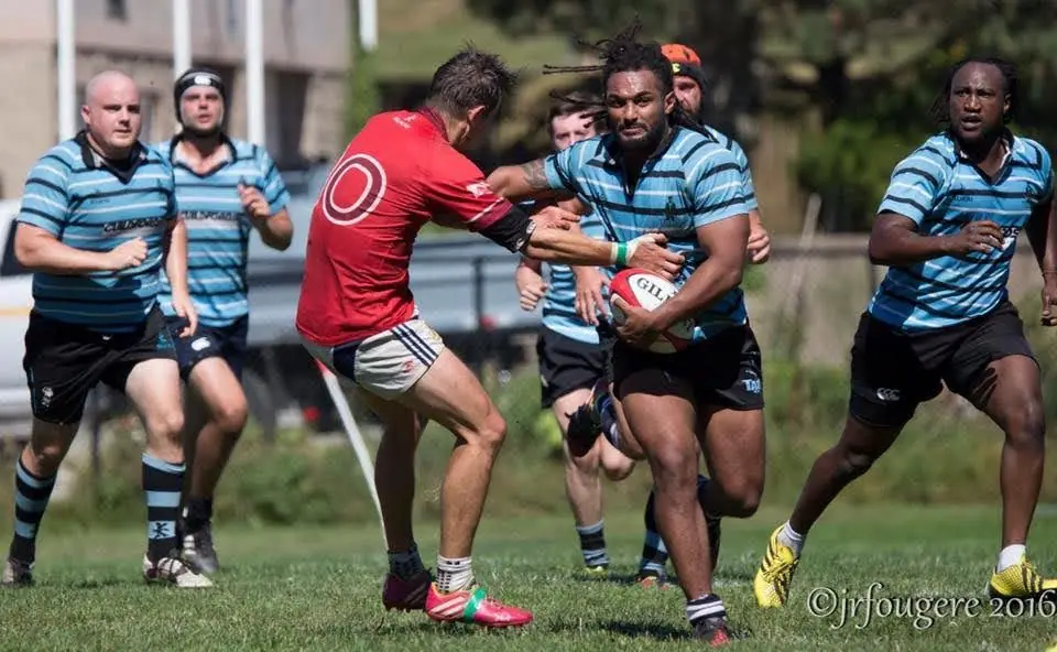 A Tars player fending off a tackler