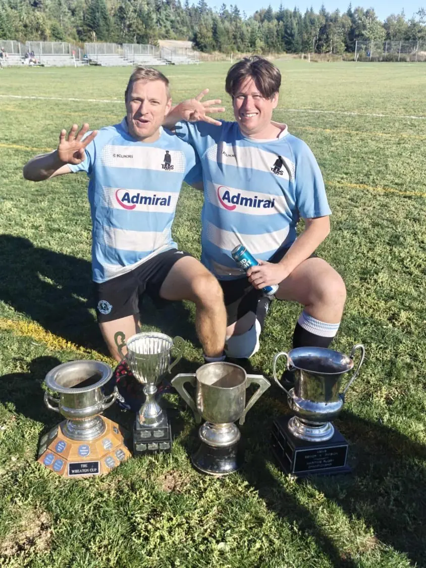 Two Tars players with the Wheaton Cup and the club’s other silverware
