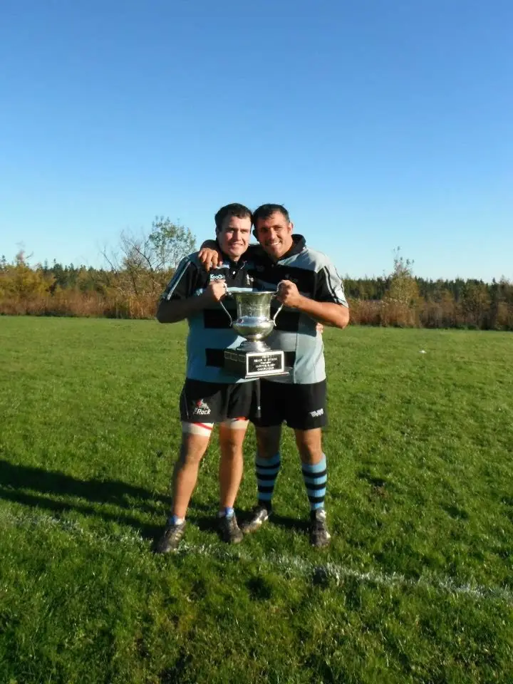 Two Tars lifting a trophy