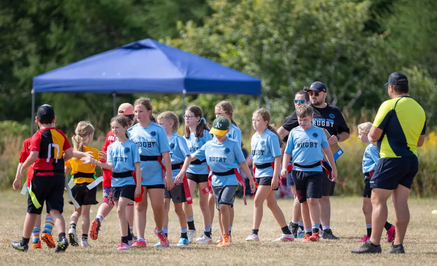 Tars minis in the handshake line after a flag rugby match