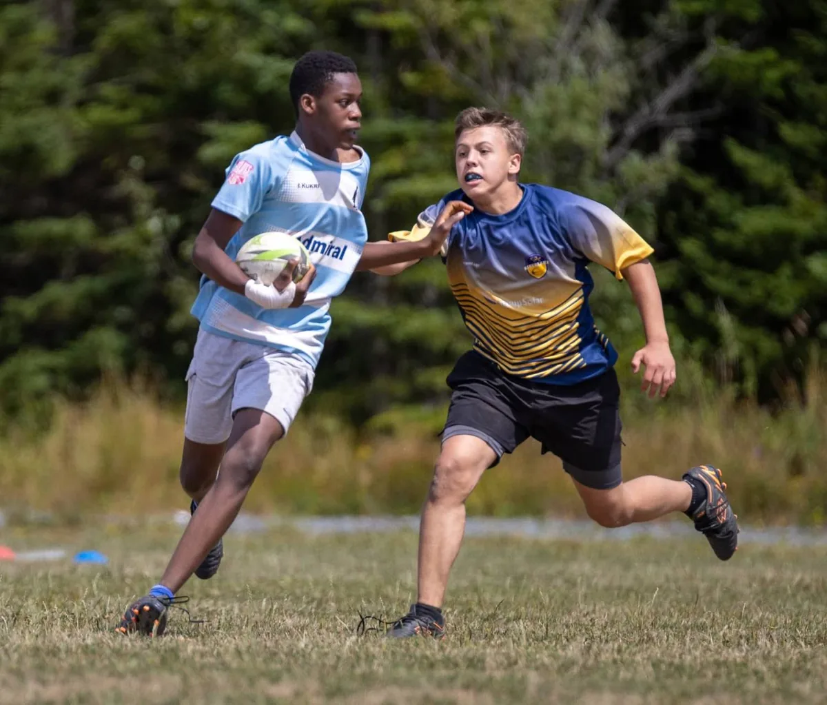 A young Tars player breaking a tackle in junior contact rugby