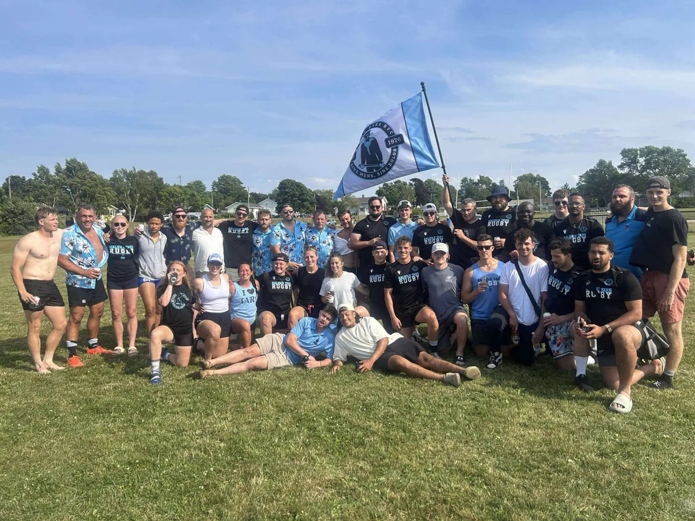 The Halifax Tars club together behind the club flag