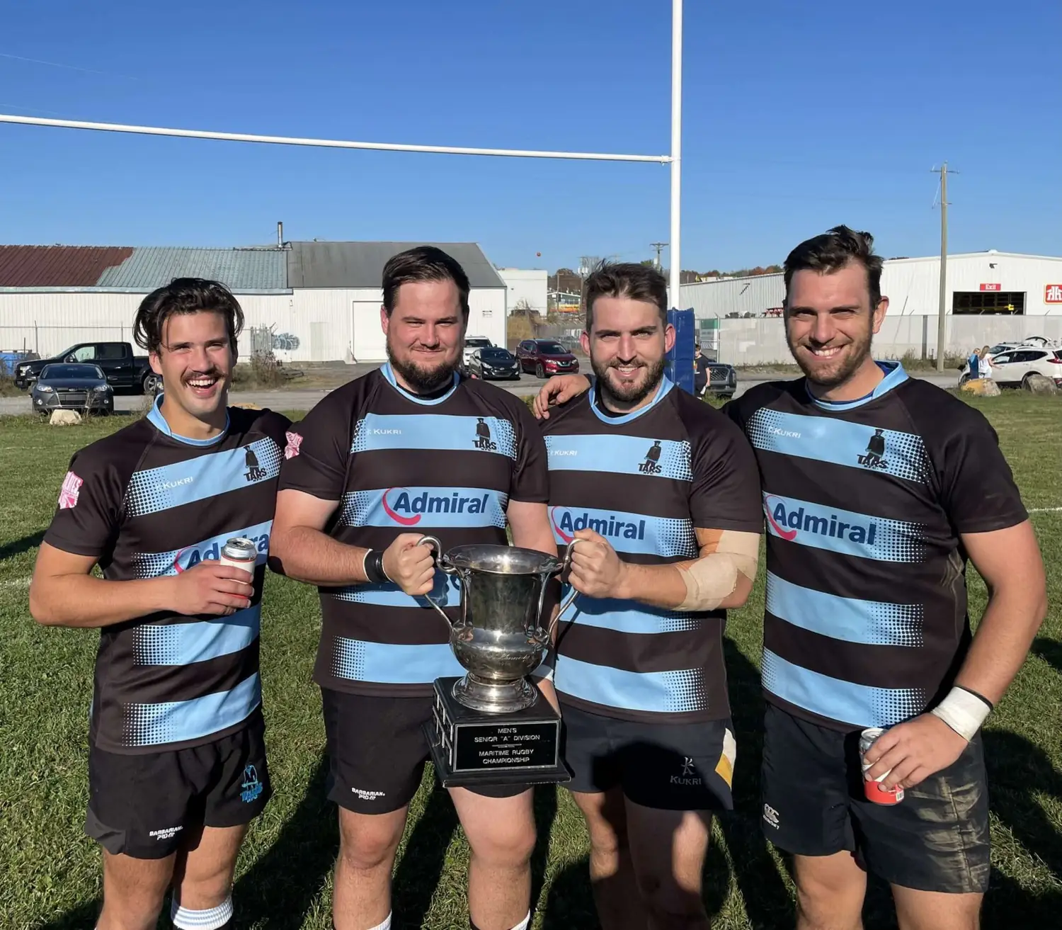 Four Tars players with the Maritime senior A championship cup