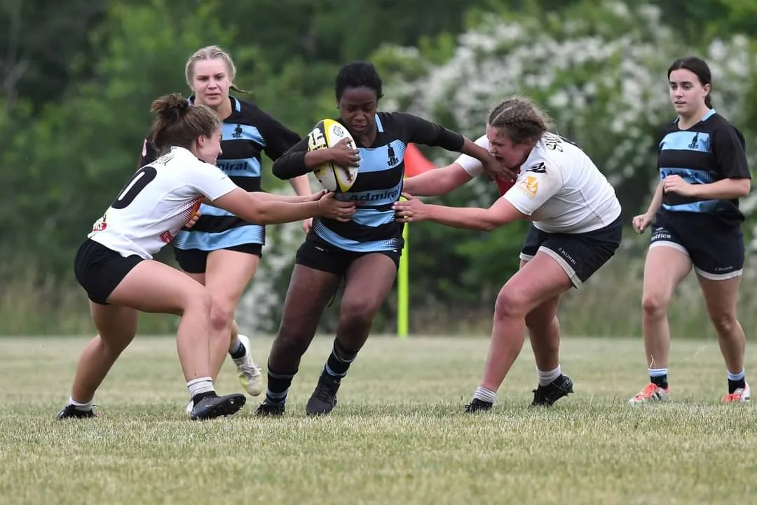 A Tars women’s Division 2 player breaking through two tacklers