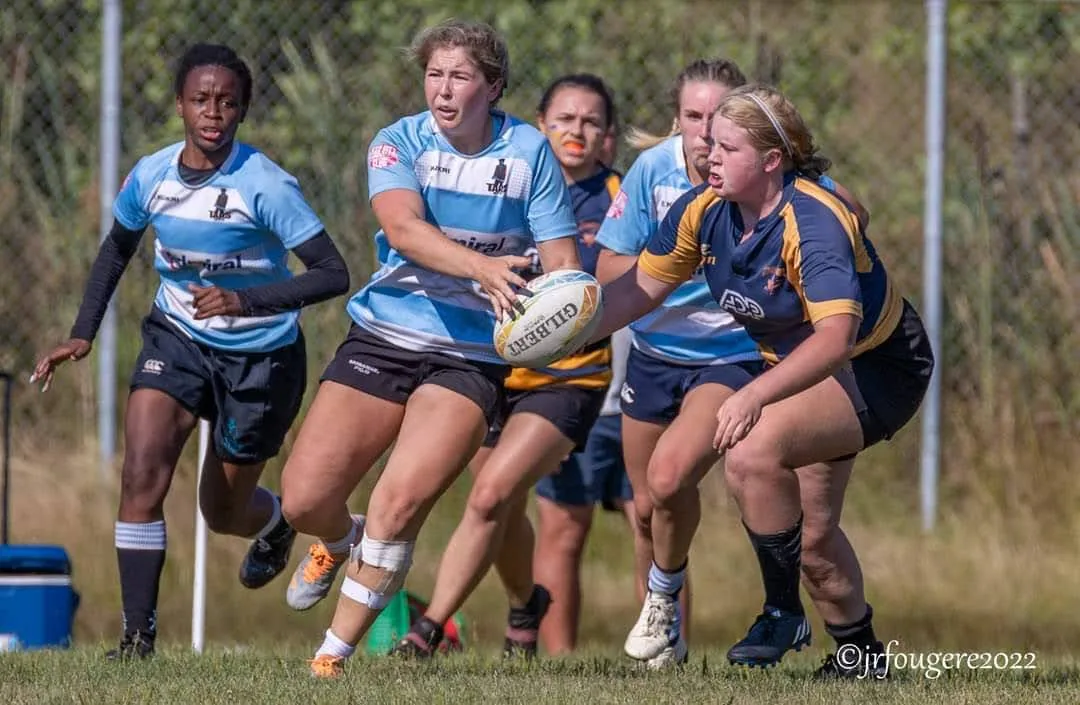 A Tars women’s Division 2 player firing a pass away under pressure